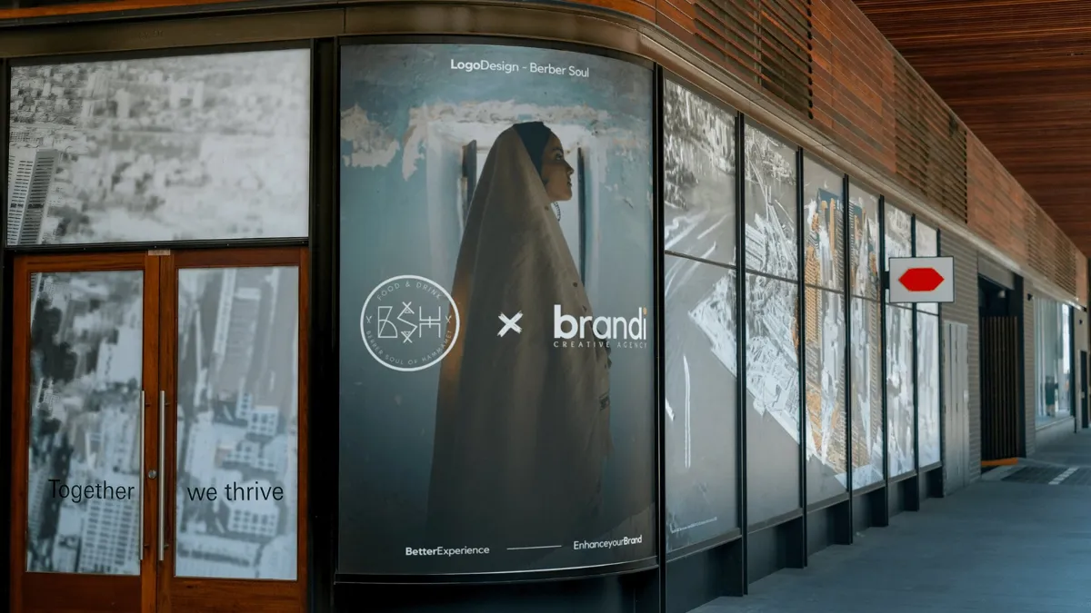 Berber Soul branding applied to a storefront window with a veiled figure