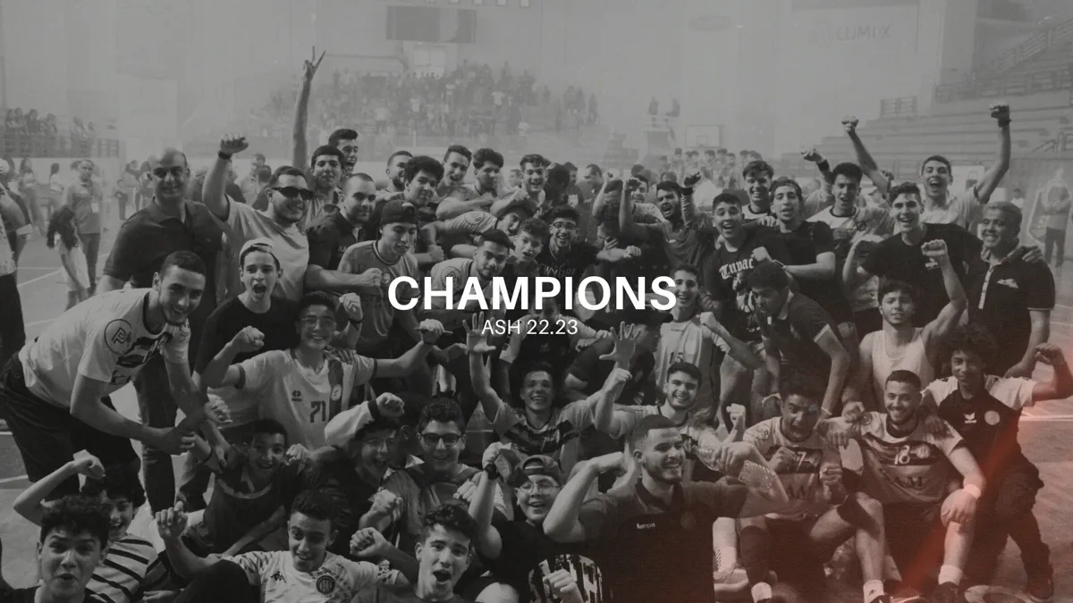 A team and its supporters celebrating a championship in black and white