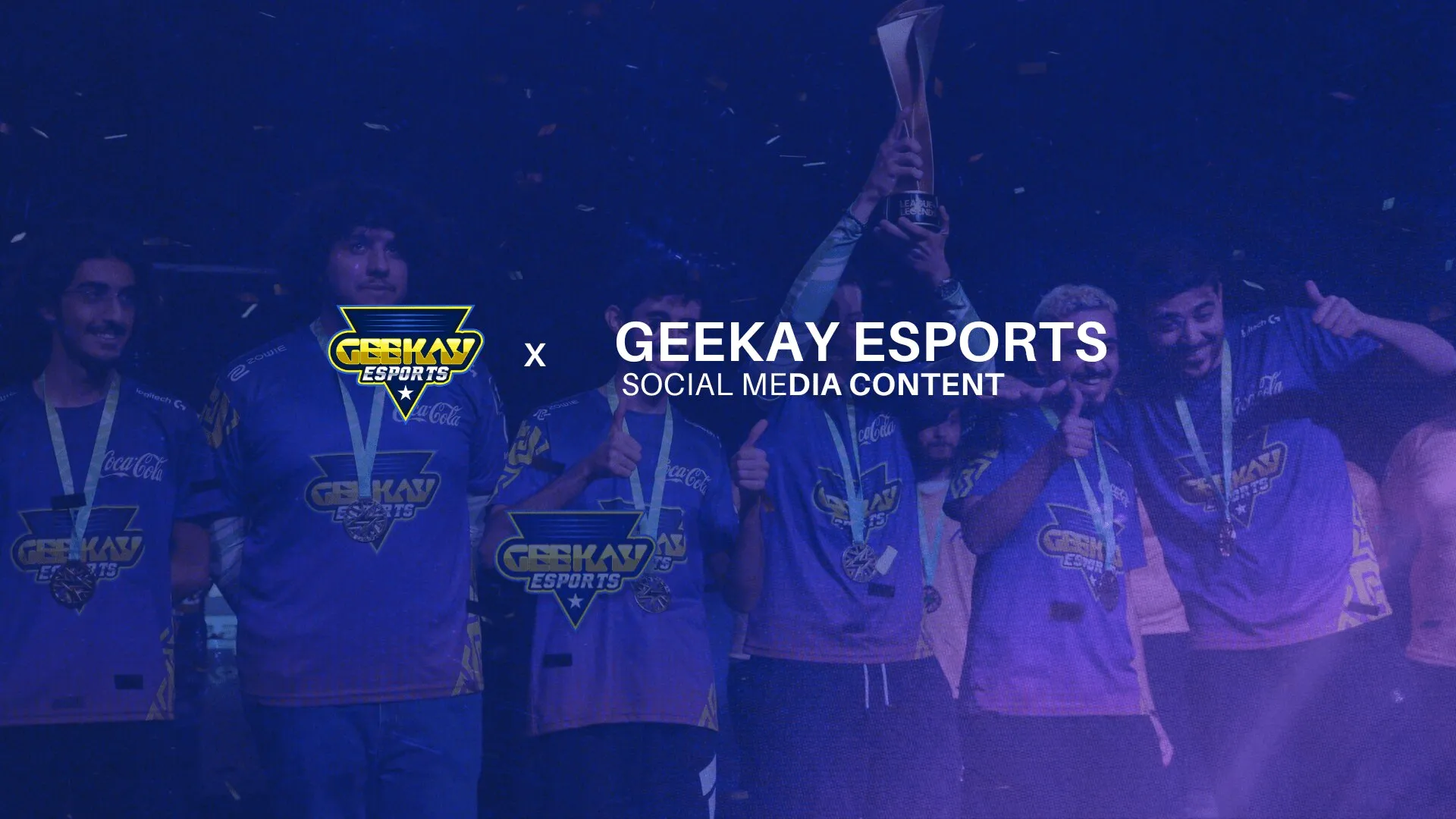 Geekay Esports players lifting a trophy under purple stage light
