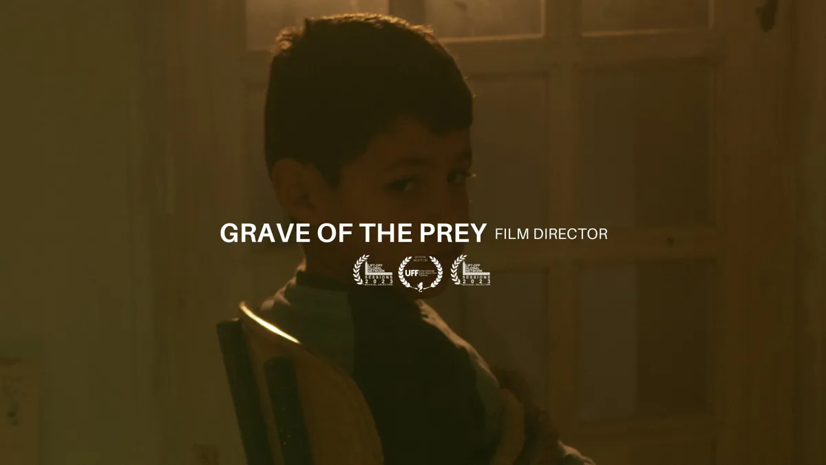A boy in warm low light looking down, with festival laurels below the title